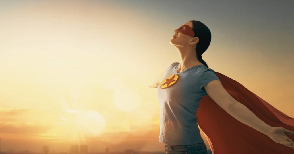 Woman wearing a superman style cape to illustrate that mindfulness is a superpower