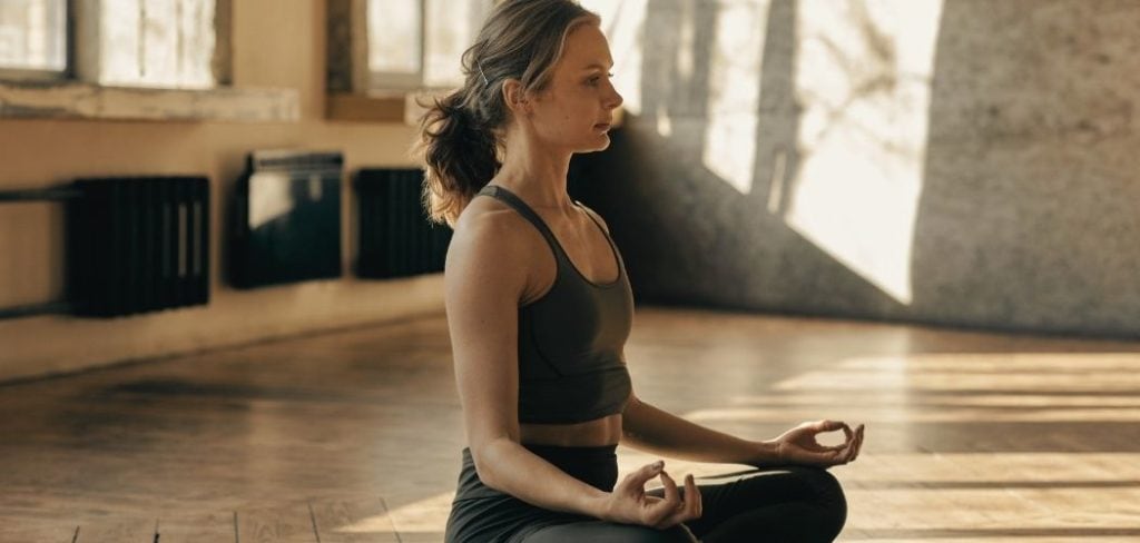 Woman meditating in a meditation studio with her eyes open
