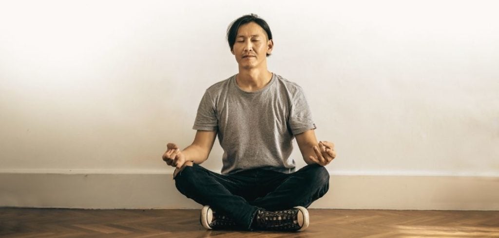 Man meditating in a room with his eyes closed