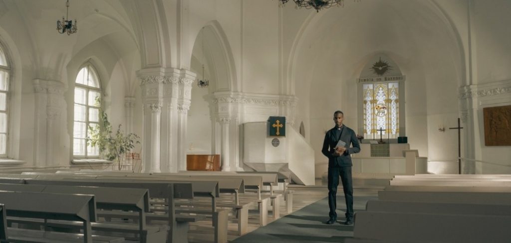 Pastor holding a Bible in a church