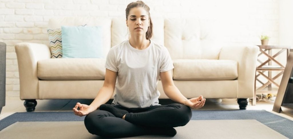 Woman sitting on the floor learning skills through meditation