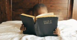 Little boy reading the Bible