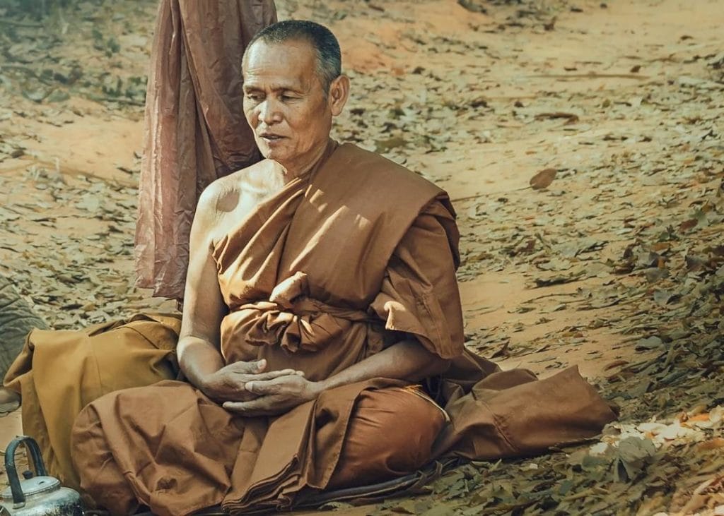 Monk meditating with open eyes