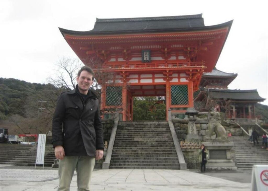 Man standing in front of a temple in Kyoto, Japan