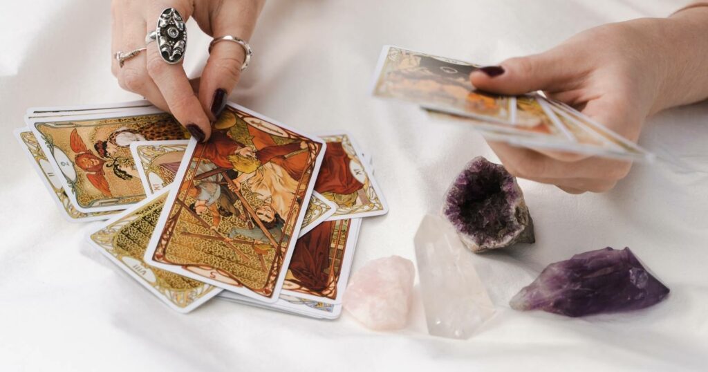 Woman playing with tarot cards and crystals