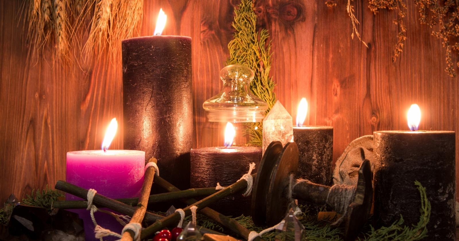 Candles and crystals by a witchy altar