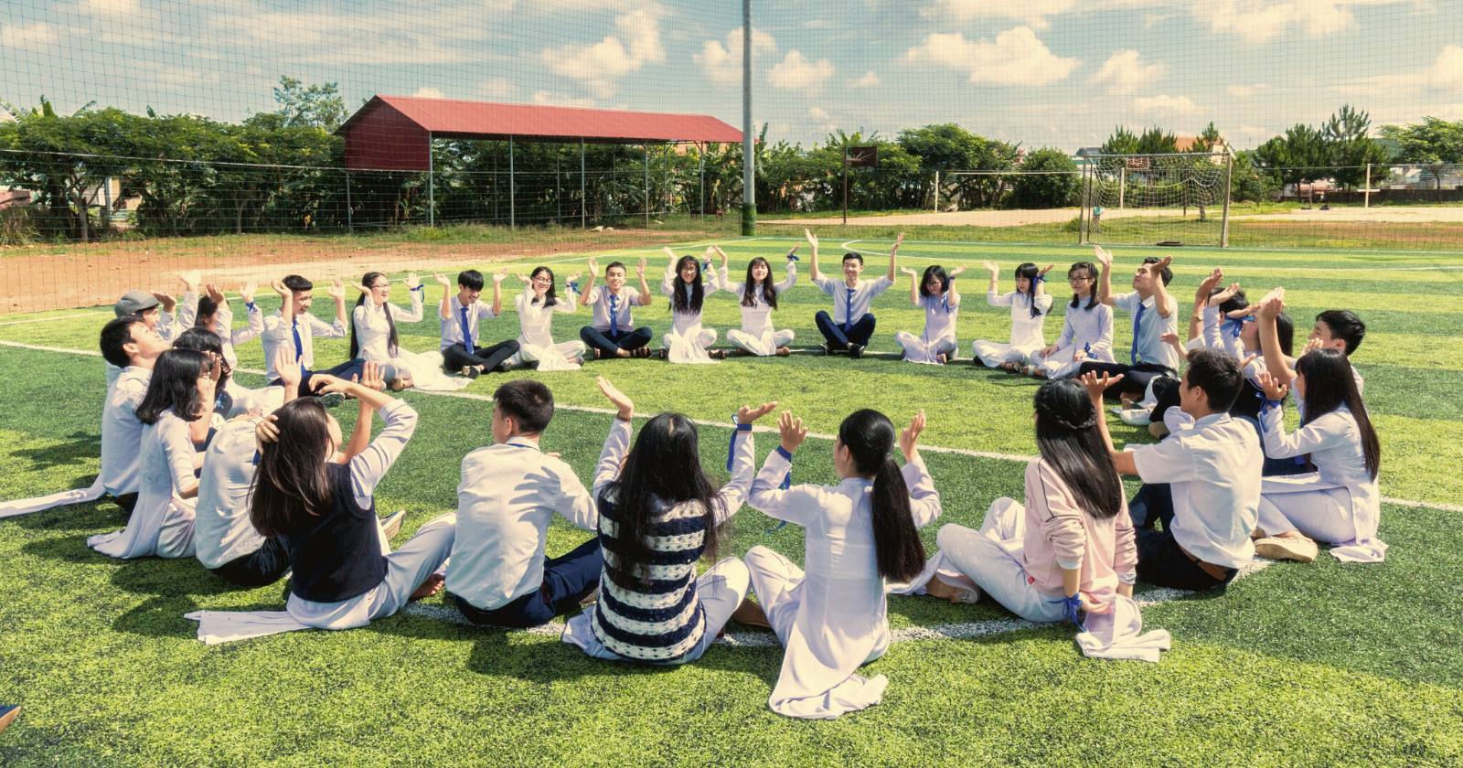Middle schoolers doing a mindfulness activity outside in a field