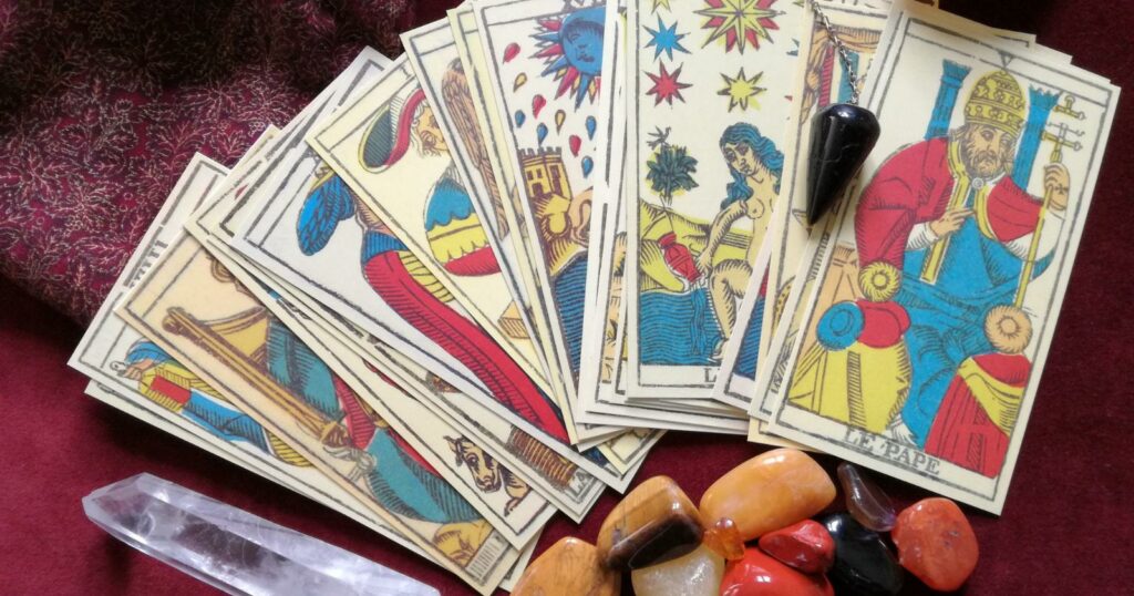 Tarot Cards and gemstones on a cloth background